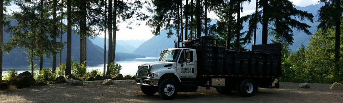 Mason Country Garbage & Recycling truck parked in front of a lake.